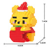 A yellow animal building block model kit resembling a bear wearing a red Santa hat and red clothing.