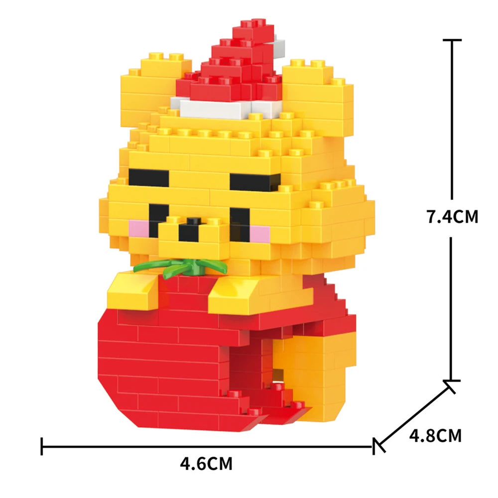 A yellow animal building block model kit resembling a bear wearing a red Santa hat and red clothing.