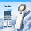 A white Kinscoter handheld fan with a grille, cable, and lanyard is shown resting on snow.