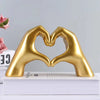 Gold heart-shaped resin hand sculpture for desk or shelf
