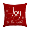 A deep red cushion cover featuring white script spelling Joy with a bow and wreath design.