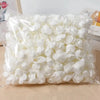 A clear plastic bag filled with white PE foam artificial rose flowers for DIY decor