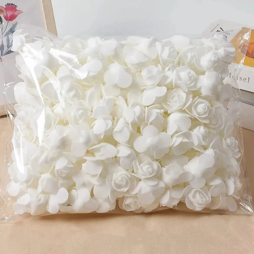 A clear plastic bag filled with white PE foam artificial rose flowers for DIY decor