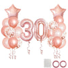 A collection of rose gold foil balloons including a number 30 and star shapes for birthday party decor