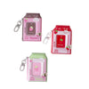 Pink and green plastic photo keychains shaped like milk bottles with a strawberry design