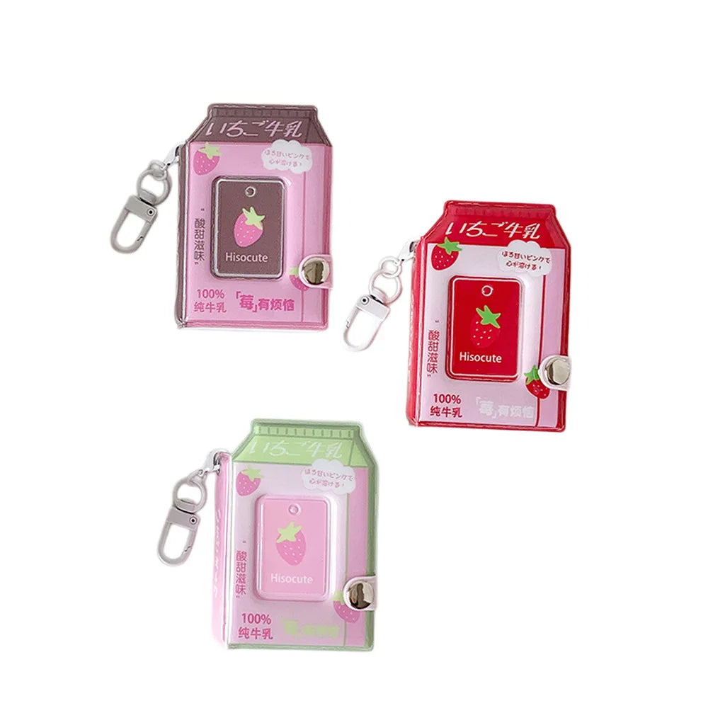 Pink and green plastic photo keychains shaped like milk bottles with a strawberry design