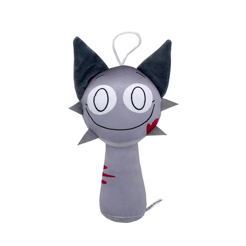 A gray plush toy shaped like a cat head with pointed ears and a pink heart detail.