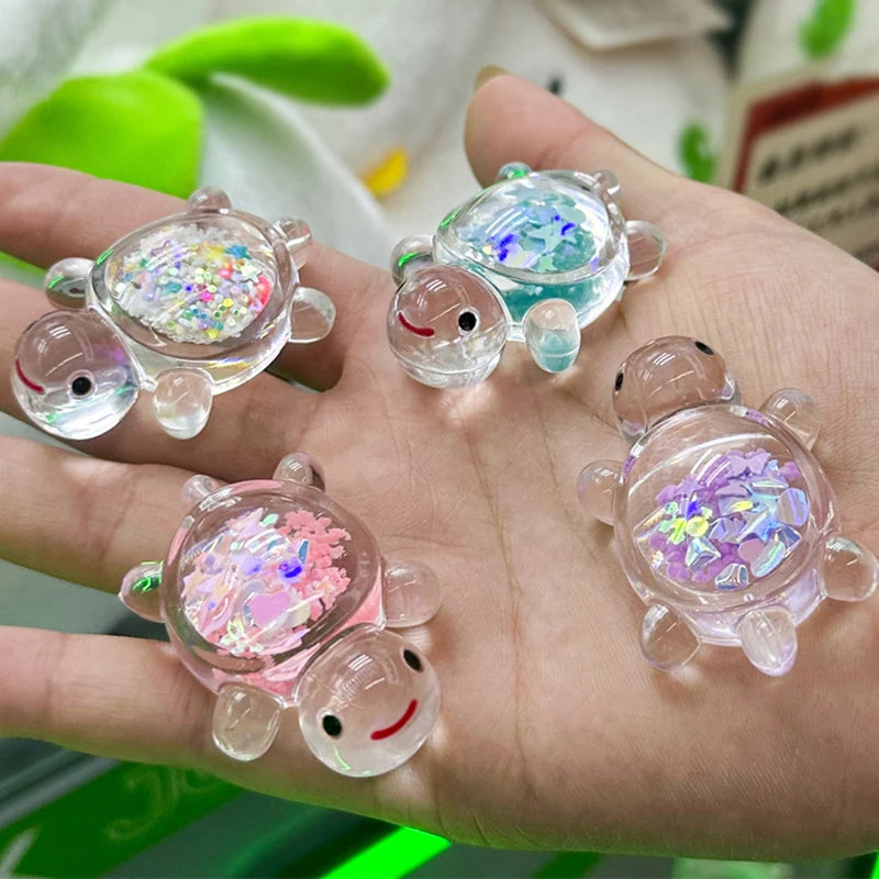 Several glow-in-the-dark mini sea turtle figurines are held in a hand, showcasing iridescent and colorful details.