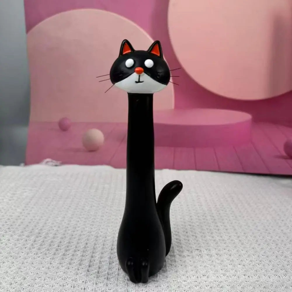 A black cat-shaped resin vase with white facial features is displayed against a pink background.