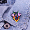 An enamel pin badge featuring a cartoon character with a burger design on a denim shirt.