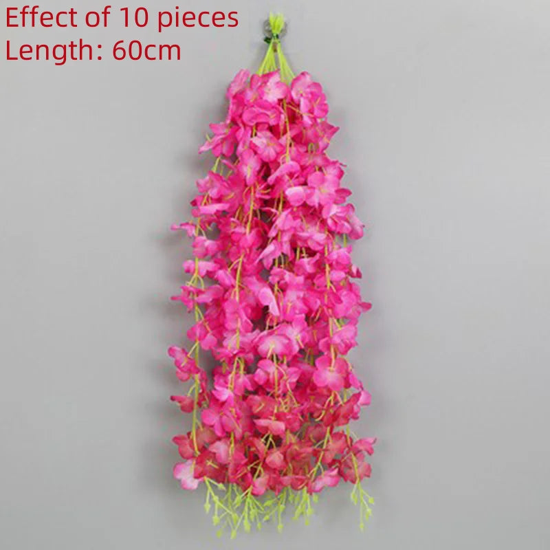 A vertical arrangement of 10 pink artificial wisteria flower pieces forming a long garland.