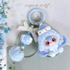 A fluffy blue heart plush keychain charm with a light purple wing and a blue bead on a silver ring.