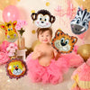 A collection of foil balloons featuring cartoon animals like a monkey and tiger in pink and gold colors.