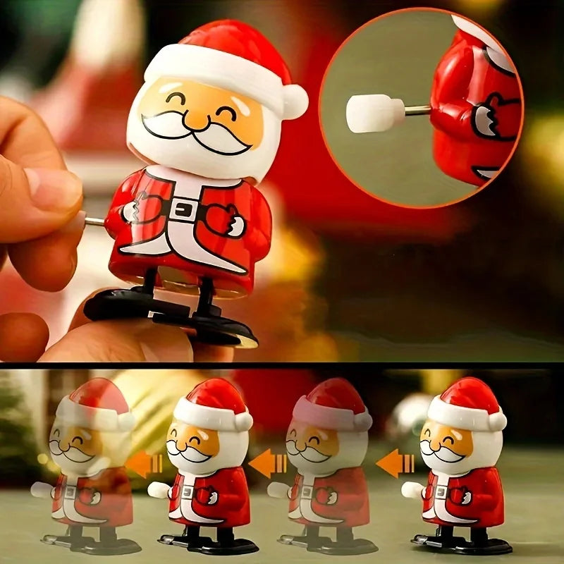 A hand holds a red and white clockwork wind-up figurine of Santa Claus for festive decor.
