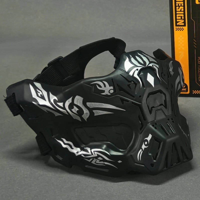 Black tactical silicone half-face mask with white camouflage design shown on a gray surface.