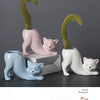 A set of three ceramic cat planters featuring different colored cats and succulent plants with curved tails.