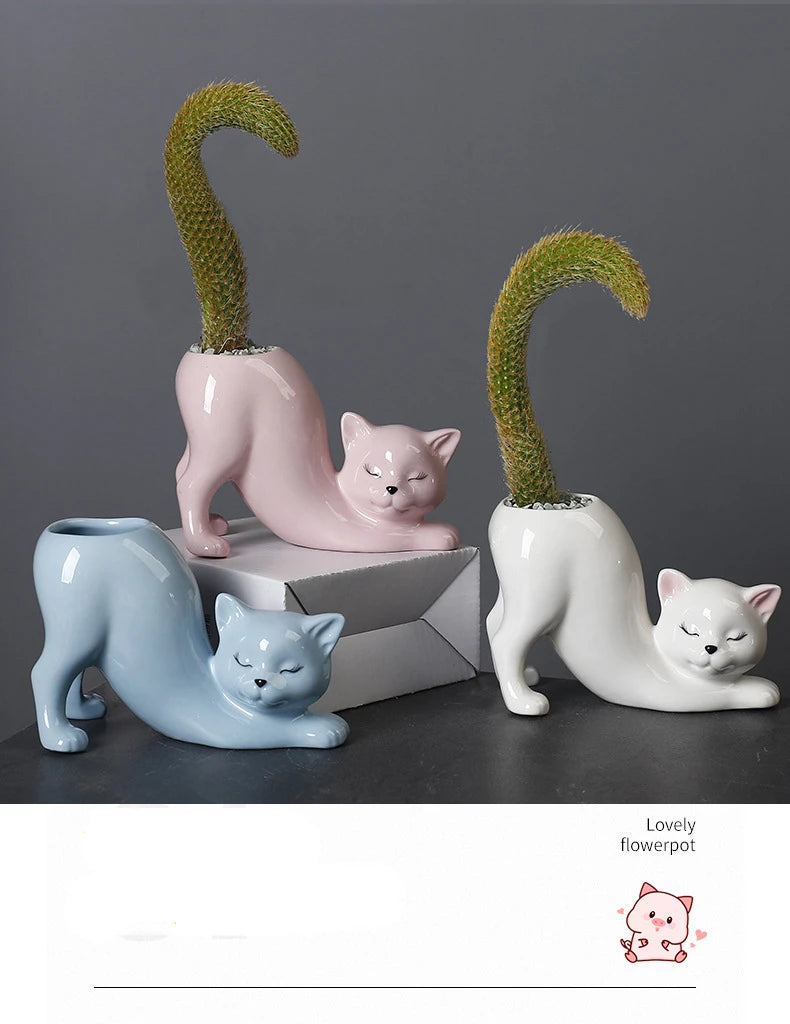 A set of three ceramic cat planters featuring different colored cats and succulent plants with curved tails.