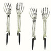 A set of Halloween skeleton bone garden stakes featuring skull and hand designs.