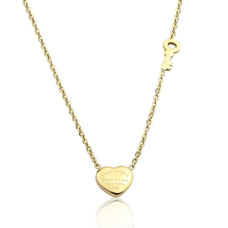 Gold-tone heart lock key pendant necklace on a gold chain