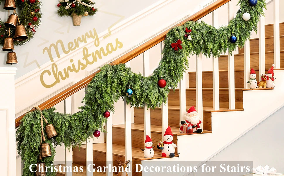 A festive Christmas garland decorated with evergreen branches, ornaments, and Santa figures adorning a wooden staircase.