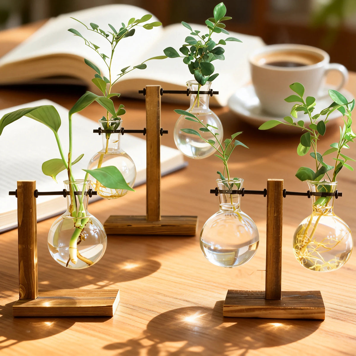 A glass hydroponic terrarium vase with a wooden stand holds green plants on a wooden table.