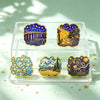 A clear tray holds five enamel pins featuring Van Gogh's art, including Starry Night and other classic paintings.