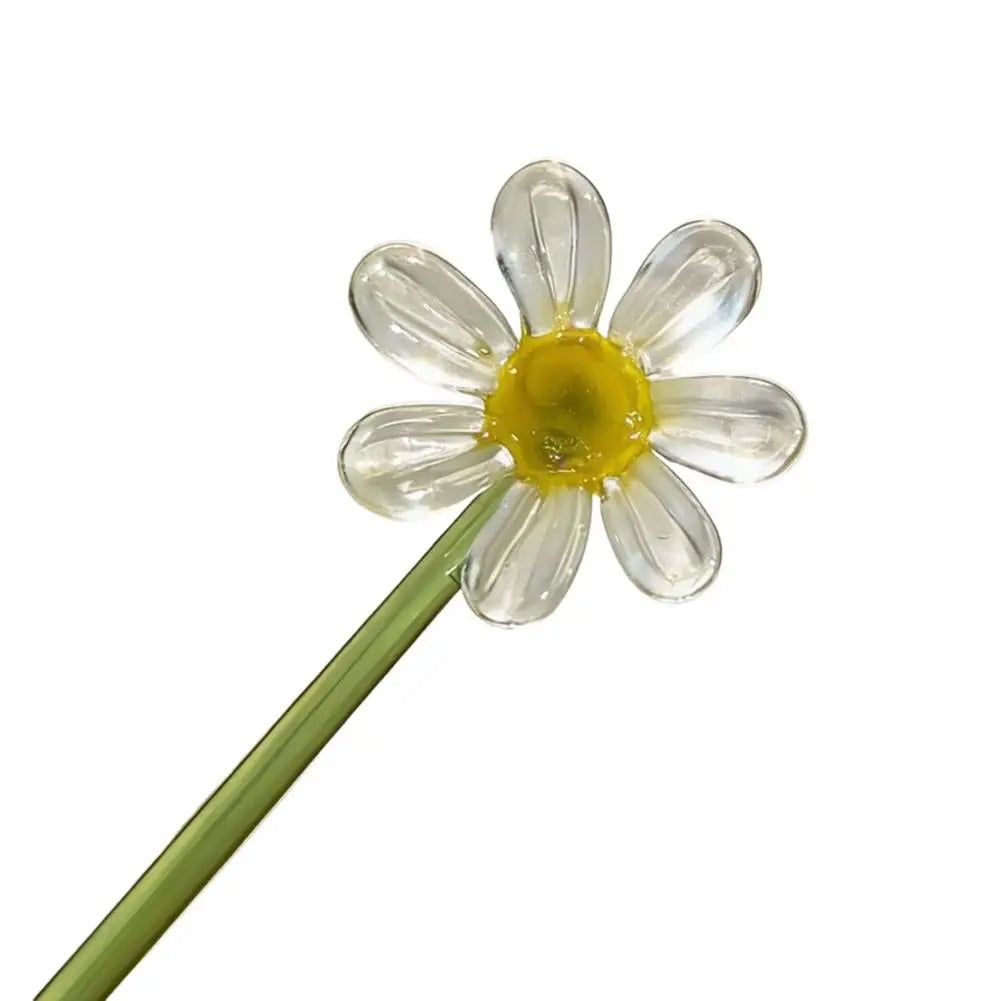 Handcrafted blue glass flower sculpture with a yellow center on a green stem