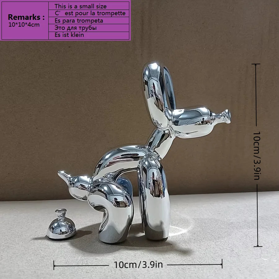 A silver sculpture of a dog in a squatting pose, designed as modern art decor.