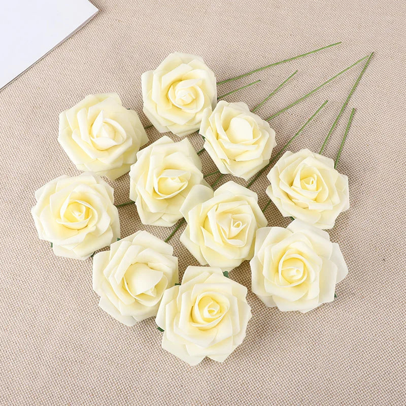 A collection of twenty creamy white foam rose stems arranged on a beige fabric background.