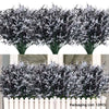 A bundle of artificial lavender stems with dark green foliage and white flowers displayed in a vase.