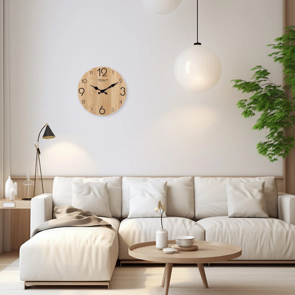 A modern living room features a light wood grain wall clock above a white sofa and a large spherical pendant lamp.