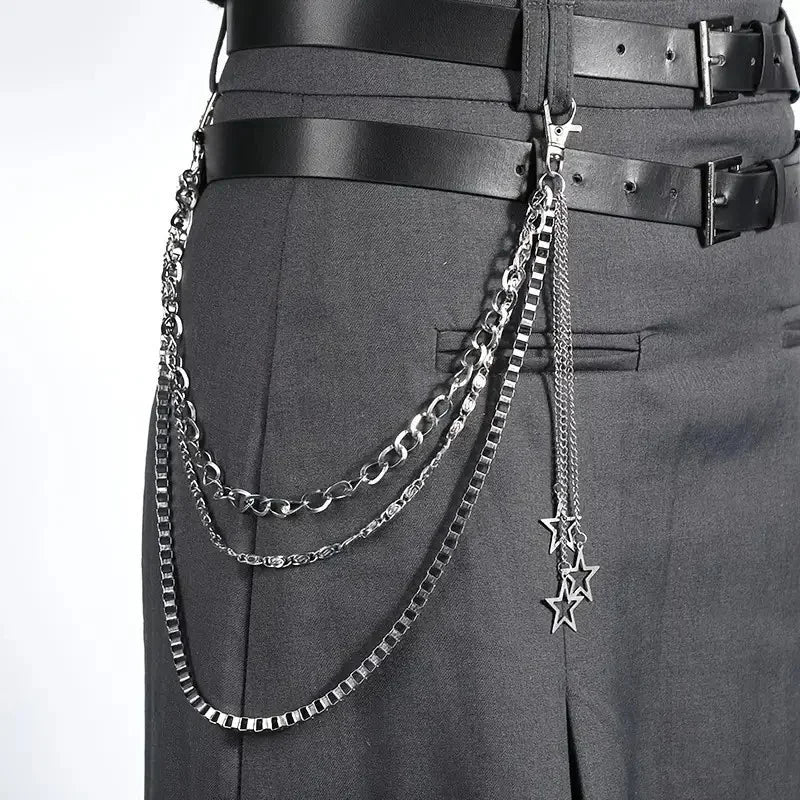 A close-up of a black belt featuring layered silver chains and a star charm.