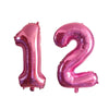Pink helium foil number balloons shaped like 1 and 2 for a birthday party