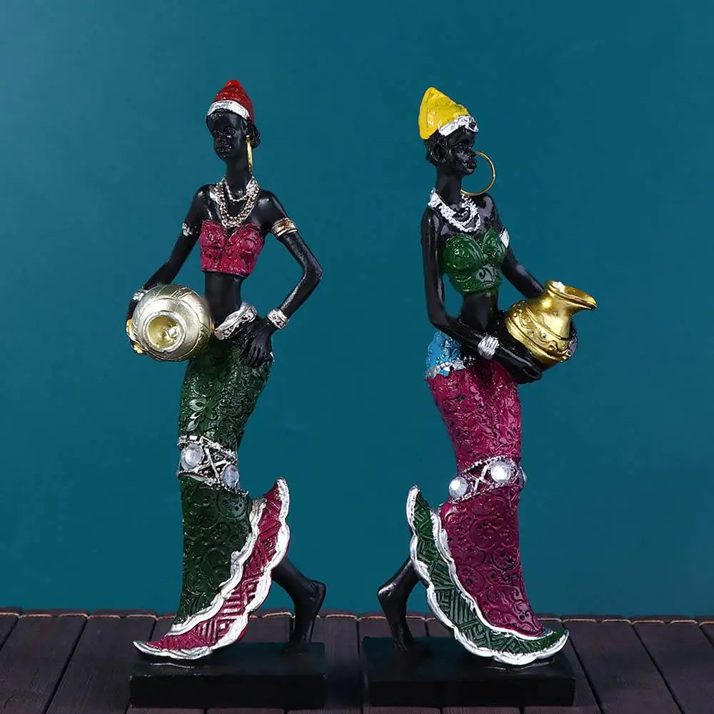 Hand-painted resin statue of an African tribal lady with gold jewelry and colorful traditional attire.