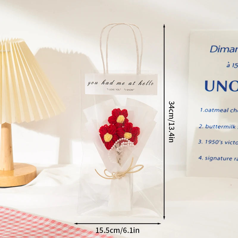 A clear cellophane bag tied with twine containing a handmade crochet flower bouquet for special occasions