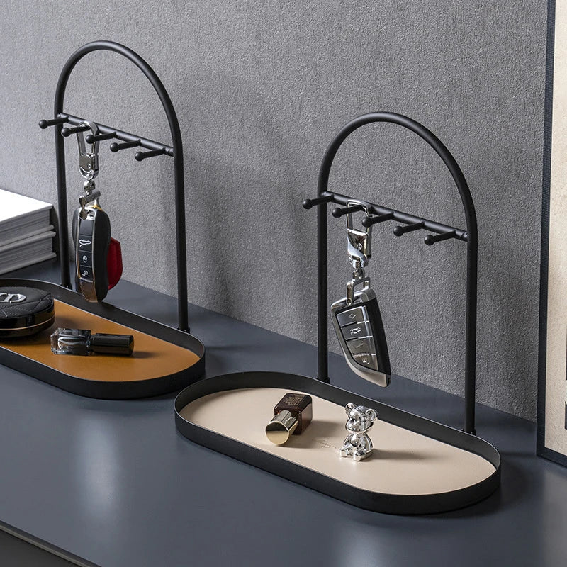 A black wrought iron desk organizer rack holding various leather and metal desk accessories.