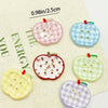 A collection of eight heart-shaped checkered fridge magnets in various pastel colors like pink, blue, yellow, and green.