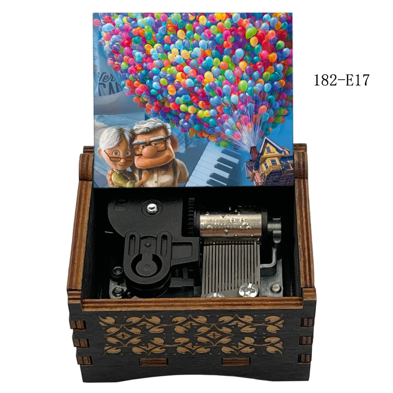 A wooden music box with a lid featuring a colorful balloon display and a scene of two smiling people.