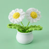 Hand woven white and yellow daisy flowers in a green pot