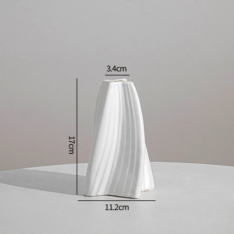 White ceramic style plastic vase with vertical ridges shown from the side.