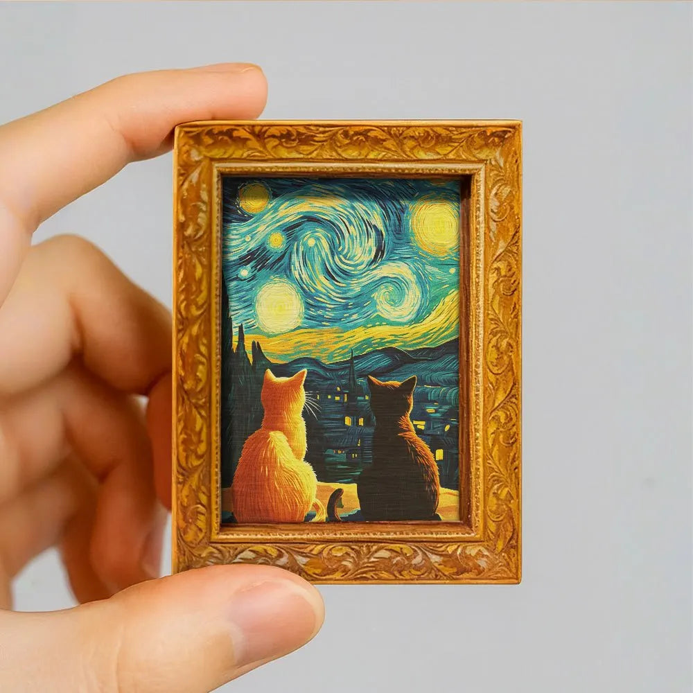 A framed print featuring a Van Gogh style starry sky with cats in a wooden frame.