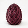 A dark burgundy, textured dragon egg stress relief toy with a pyramidal shape.
