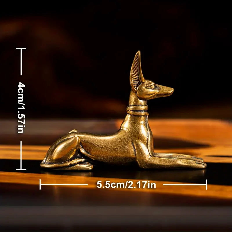 A vintage brass pharaoh hound statue with an Egyptian-inspired design, shown in profile against a dark background.