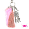 Pink bohemian dream catcher keychain featuring a feather tassel and silver charms.