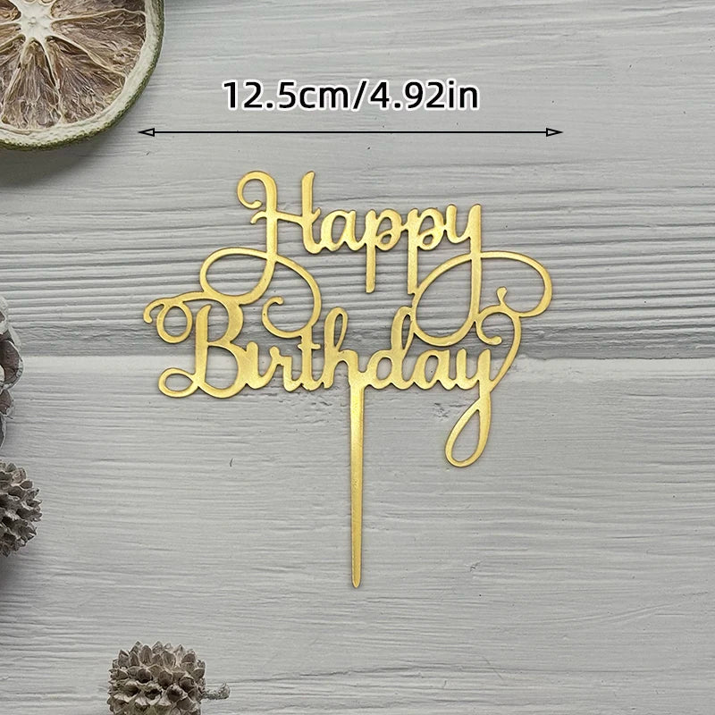 Elegant gold acrylic birthday cake topper with cursive lettering on a wooden surface.