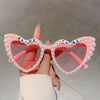 Pink pearl decor glasses set with bride to be text displayed on a hand