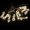 String of warm white LED curtain fairy lights with small bulbs and wires against a dark background