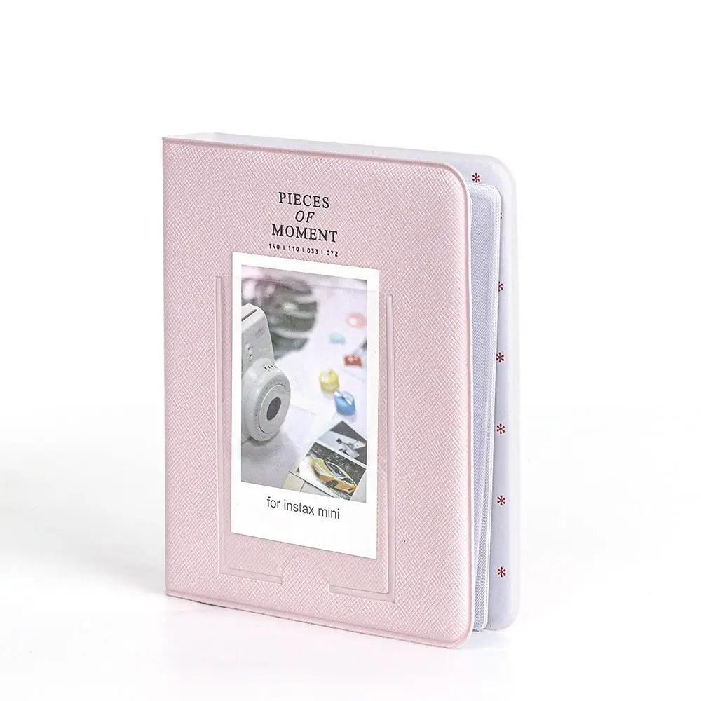 A pink 64-pocket photo album for instant cameras with a clear window display.