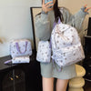A woman holds a white backpack set featuring a bow print and matching accessories.