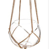 Handmade macrame plant hanger with a clear glass bowl suspended by natural cotton rope.